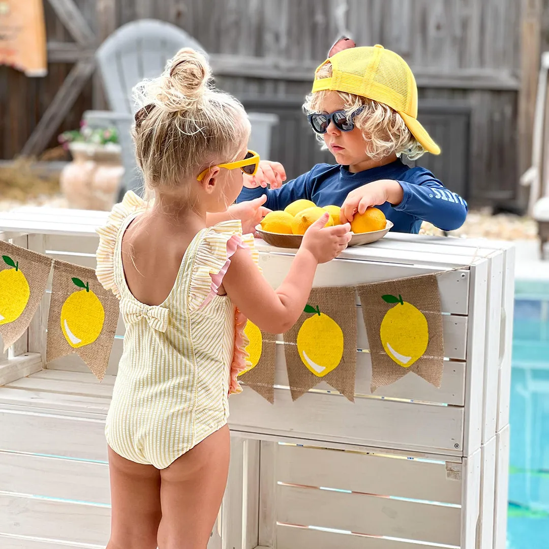 RuffleButts Toddler Seersucker One Piece with Roshambo Yellow Sunglasses
